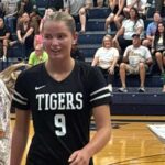 Hernando beats Lewisburg 3–1 in county volleyball showdown Hernando volleyball player wearing a Tigers No. 9 jersey in the gym.