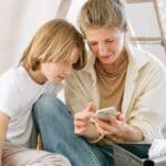 DeSoto County Sheriff Launches OffenderWatch Alerts for Parents Mother and son look at a smartphone, illustrating DeSoto County OffenderWatch safety alerts