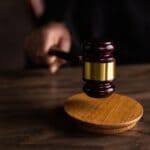 DeSoto County Woman Gets 30 Months for Straw Gun Purchase Wooden gavel on a sound block, illustrating a federal straw purchase sentencing