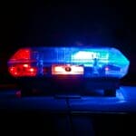 Ex-DeSoto County Schools Employee Charged in Child Sex Case Police light bar flashing red and blue at night, illustrating a DeSoto County Schools employee charged in a child sex case