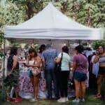 Hernando Water Tower Festival Draws Record 150 Vendors Shoppers browsing vendor booths at an outdoor festival market, similar to the Hernando Water Tower Festival