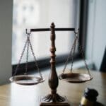Lindsey Whiteside Plea: Ex-DeSoto Youth Pastor Pleads Guilty Judge's gavel and scales of justice on a desk, illustrating the Lindsey Whiteside plea in federal court