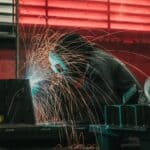 Northwest Leads $8.5M Workforce Pell Training Grant Welder creating sparks in an industrial workshop, illustrating Workforce Pell job training