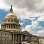 Olive Branch Cancer Survivor Lobbies Capitol Hill for Trials U.S. Capitol dome under a cloudy blue sky, where an Olive Branch cancer survivor lobbied Congress