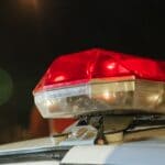 Olive Branch Motorcycle Crash Kills Rider on Goodman Road Emergency light bar on top of a police vehicle at night, illustrating the Olive Branch motorcycle crash investigation