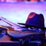 Walls Delta Festival Celebrates Town's Blues and Juke Joint Roots Electric guitar and hat resting on a stage, illustrating the Walls Delta Festival blues celebration