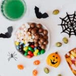 The 5 Best Halloween Party Supplies for DeSoto County Families Festive Halloween candies and decorations arranged on a white table with a spooky theme — party-table ideas for DeSoto County celebrations.