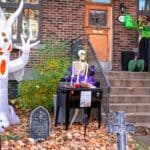 The 5 Best Halloween Yard Decorations and Inflatables for DeSoto County Homes Spooky Halloween outdoor decorations with an inflatable ghost and skeleton on a house porch