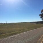 Arkabutla Dam Repairs: Phase 2 Grouting Now Complete Grass-covered embankment of Arkabutla Dam beside the dam road in DeSoto County, site of ongoing Arkabutla Dam repairs