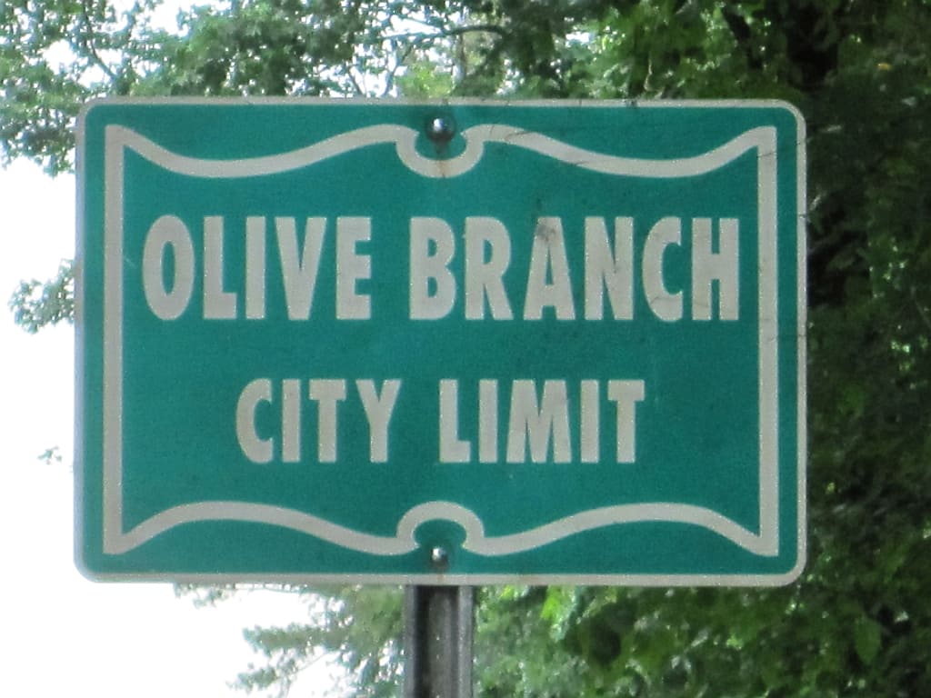 Olive Branch city limit sign, illustrating the Cascades developer arrested in Olive Branch