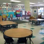 Alexa Clevenger Named DeSoto County Teacher of the Month Colorful kindergarten classroom with small tables, chairs, and student artwork, illustrating the DeSoto County Teacher of the Month story