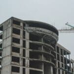 Landers Center Hotel Lags as DeSoto Board Demands Action A multistory building under construction beside a tower crane, illustrating the stalled Landers Center hotel