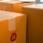 Southaven Renters Near SpaceXAI Expansion Told to Move Out Cardboard moving boxes stacked near a sunny window, illustrating Southaven renters near SpaceXAI being told to move