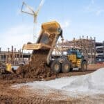 SpaceXAI Faces $6.1M MDEQ Penalties Over Southaven Sites Heavy equipment moving fill dirt at a large construction site, illustrating land disturbance at issue in SpaceXAI MDEQ penalties