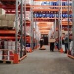 SpaceXAI Buys 3 Southaven Homes, Leases Highway 51 Warehouse Workers handling boxes inside a distribution warehouse, illustrating the SpaceXAI Southaven warehouse lease