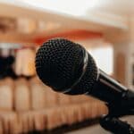 Walls Mayor Sets Listening Sessions on Town's Future Microphone on a stand in an empty meeting room, illustrating Walls listening sessions at Town Hall