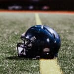 Lake Cormorant Football Player Zach Brown Gets Lung Transplant Football helmet on a field under night lights, illustrating the Zach Brown lung transplant story
